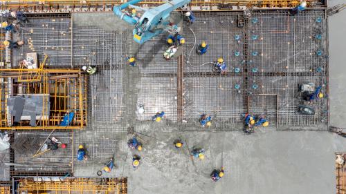 Construction workers pouring concrete