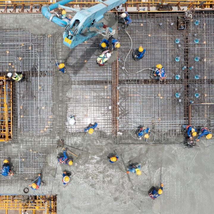 Construction workers pouring concrete